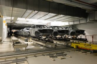 Car bodies are on assembly line. Modern automotive industry. Automobile conveyor