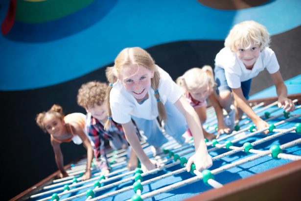 Children climbing the ropes while enjoying outdoors activities