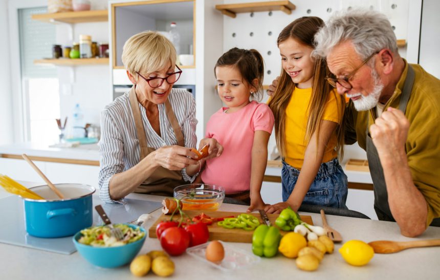 Happy grandparents having fun times with children at home