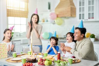 Special day. Joyful hispanic family with children looking happy, clapping while celebrating birthday