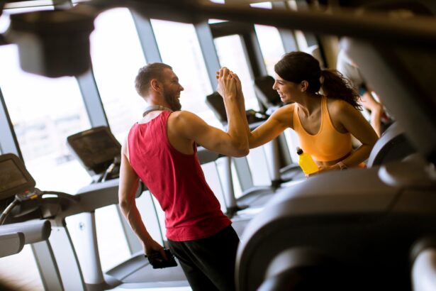 Young woman and personal trainer rest in the gym after workout